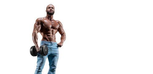 Sportsman posing on a white background in jeans with a dumbbell in his hand. Fitness