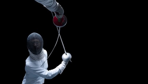 Two fencers are fighting in a tournament. The concept of fencing.