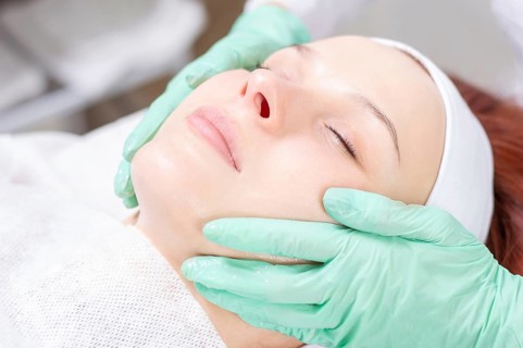 Beautiful girl gets face peeling. Skin health concept. Beauty salons.