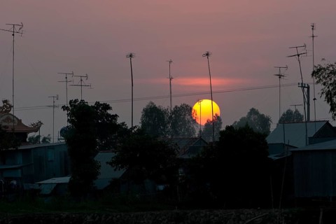 Sunset behind roofs and old television aerials