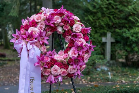 Funeral wreath with flowers at a grave