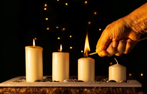 Light the third Advent candle with a matchstick