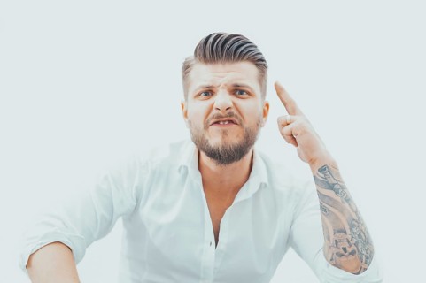Angry man threatens his opponent. The concept of domestic violence