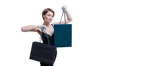 Stylish tall girl in white gloves demonstrates a black luxury package. The concept of safe shopping during a pandemic
