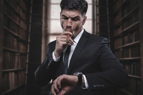 Portrait of a stylish man in a suit with a cigar. Business concept.