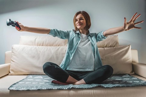 Portrait of a girl with a joystick in her hands. The concept of video games