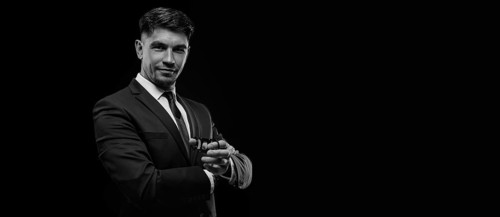 Portrait of a stylish man in a suit with a cigar. Business concept.