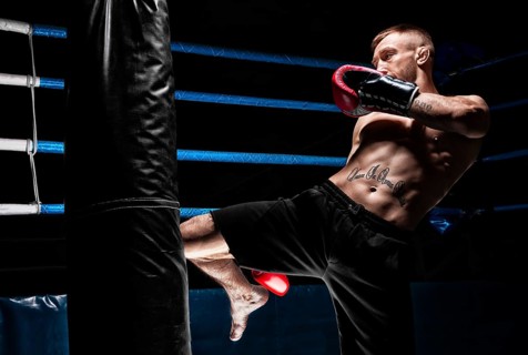 Kickboxer hits the bag with his knee. Training a professional athlete. The concept of mma
