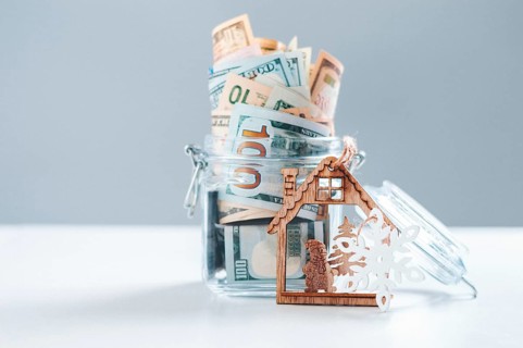 Glass piggy bank full of money. Christmas and New Year concept. Gift expenses.