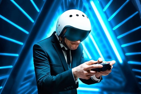 Portrait of a man in a suit and helmet of a pilot with a joystick in his hands. He enthusiastically plays a computer game. Game space. Game concept.