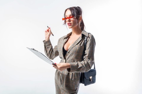Charming young girl answers the test questions. White background. University admission concept.