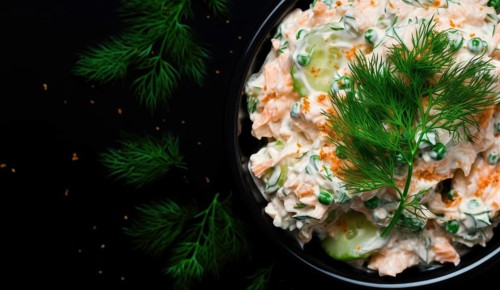 Boiled potatoes in white sauce. Traditional potato salad decorated with dill. Close-up view AI generated