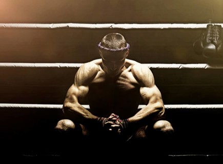 World champion in Thai boxing is sitting in the ring and getting ready for the next fight. The concept of sport