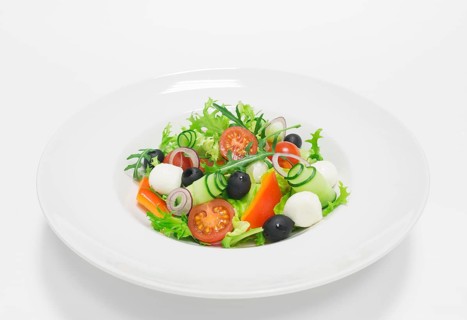 Classic greek salad. Top view. White background. Healthy eating concept.