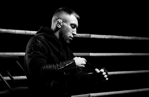 Mixed martial artist wraps bandages around his fist. Concept of mma