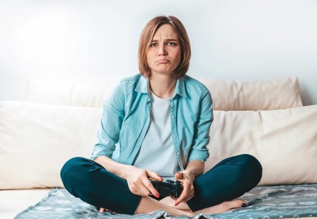 Girl with a joystick in her hands cries because of a defeat in the game. ESports concept.