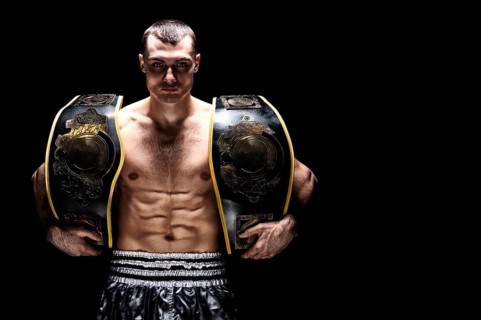 Kickboxing world middleweight champion stands with two belts. The concept of a healthy lifestyle