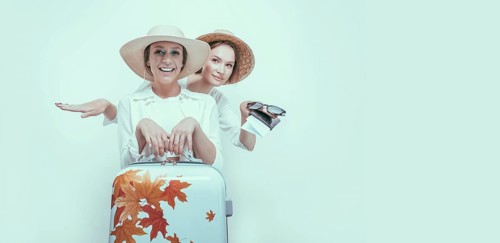 Portrait of two smiling women with passports