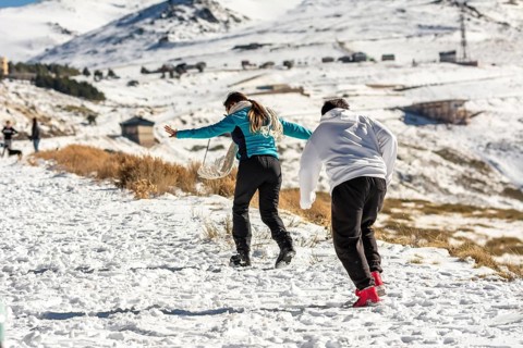 Icy adventures await! A Latino family revels in the snowy hills of Sierra Nevada