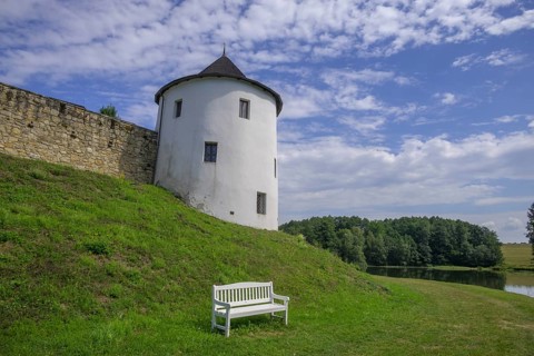 Tower of the fortified village and white bench