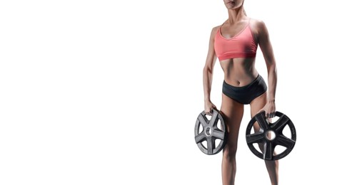 Delightful athlete posing in the studio with weights in her hands. The concept of sports