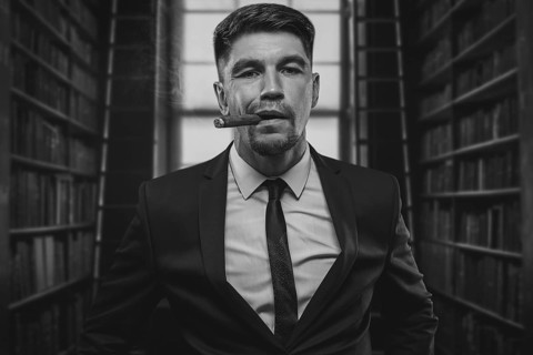 Portrait of a stylish man in a suit with a cigar. Business concept.