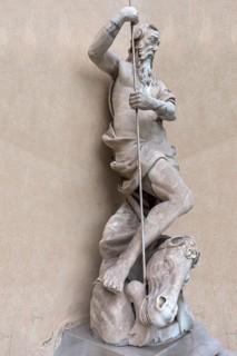 Large male sculpture with horse's head in the garden of Palazzo Reale