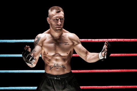 Mixed martial artist posing in boxing ring. Concept of mma