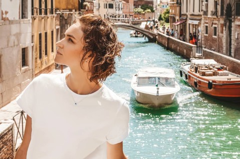 Portrait of a charming girl with a view of santa maria della salute. Travel and vacation concept.