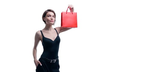 Portrait of stylish adult woman posing in studio on white background with red gift bag. Valentine's Day concept. Holidays and gifts
