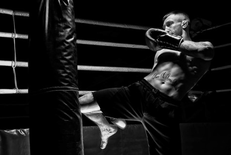 Kickboxer hits the bag with his knee. Training a professional athlete. The concept of mma