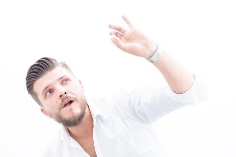 Stylish man in a shirt shows an ok sign right at the camera. The concept of success and support
