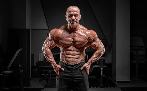 Professional weightlifter posing in the gym. Classic bodybuilding.