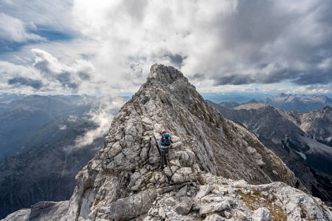 Mountaineer on a narrow rocky ridge