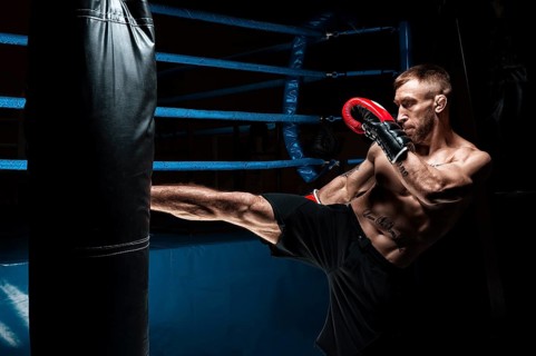 Kickboxer kicks the bag. Training a professional athlete. The concept of mma