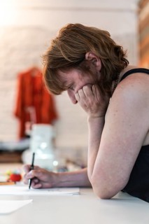 Side view of a fashion desinger creating new designs