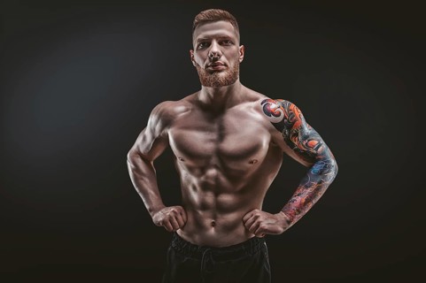 Young muscular guy posing in the studio. Fitness and nutrition concept.