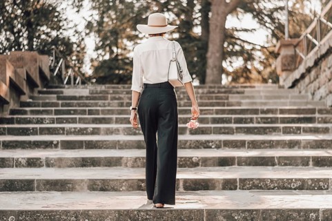 Portrait of a charming girl climbing the stairs to Piazzale Michelangelo in Florence. The concept of tourism