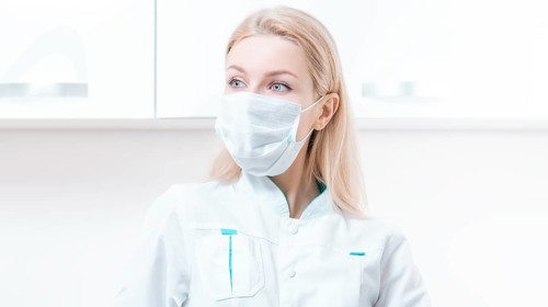 Portrait of a blonde girl in a mask. Coronavirus epidemic concept. Pandemic.