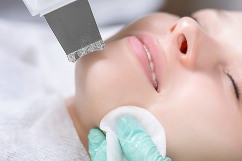 Young pretty woman receiving treatments in beauty salons. Ultrasonic cleaning procedure. Hardware cosmetology.