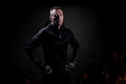 Mixed Martial Arts fighter posing on a metal grid background. Concept of mma