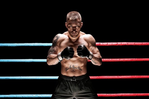 Mixed martial artist posing in boxing ring. Concept of mma