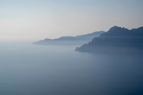 View of a Corsican coastal landscape in fog as texture or background