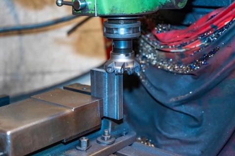 The CNC milling machine cuts the metal parts with a milling machine tool. Numerical control workshop