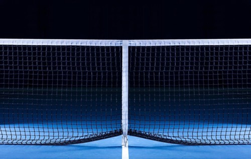 Image of a tennis court with a stretched net. Sports concept.