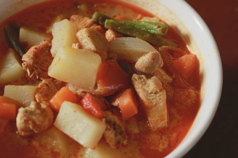 A bowl of hearty chicken stew with potatoes
