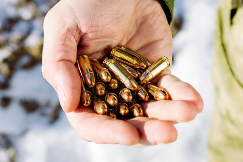 The fighter holds a handful of bullets in his palm for weapons.