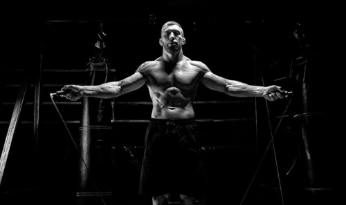 The athlete jumps on a skipping rope in the gym opposite the boxing ring. The concept of sport