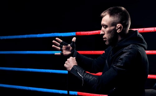 Mixed martial artist wraps bandages around his fist. Concept of mma