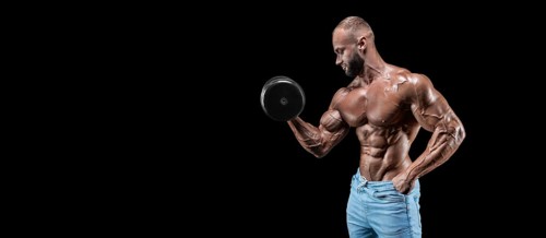 Isolated muscular man on a black background. Bodybuilding and fitness concept. Panorama.